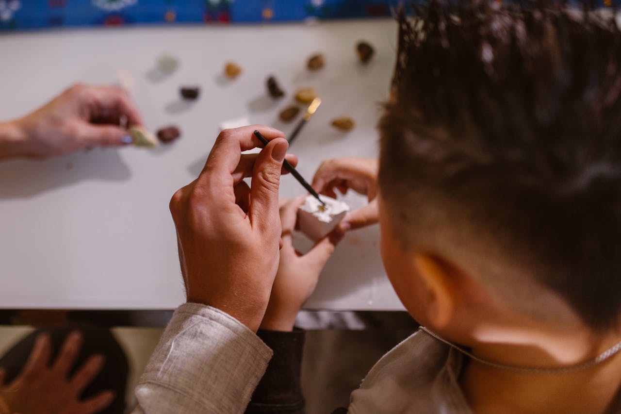 services-02 Children participating in a hands-on arts and crafts activity, focusing on creativity and skill development.